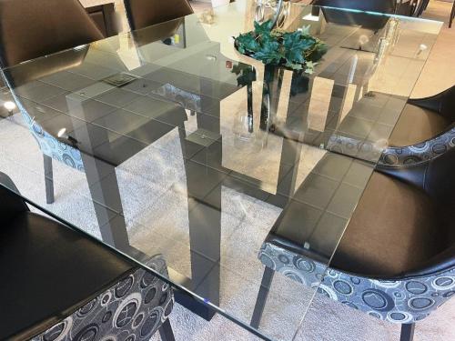 Glass Top Dining Table With Geometric Wood Base